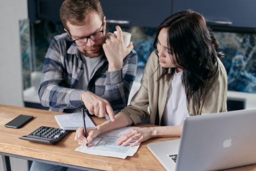 Man and woman look at documents