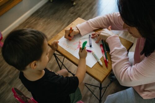 child drawing with adult