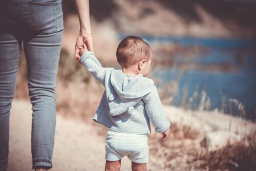 parent holding child's hand