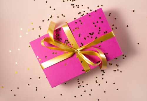 pink present with gold confetti