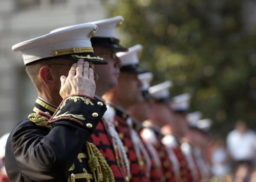 people in military uniforms saluting