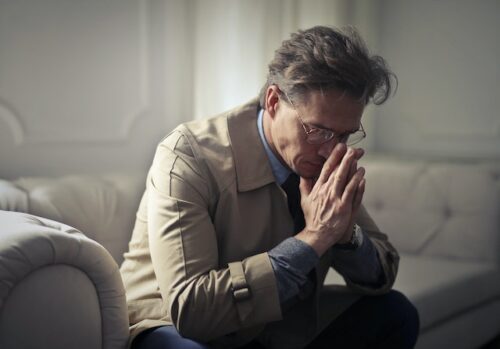 stressed man sitting on couch