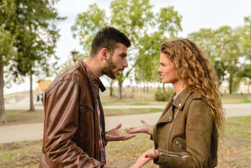 man and woman in park disagreement