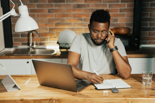 man doing calculations at desk